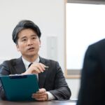 男性の面接官が質問している